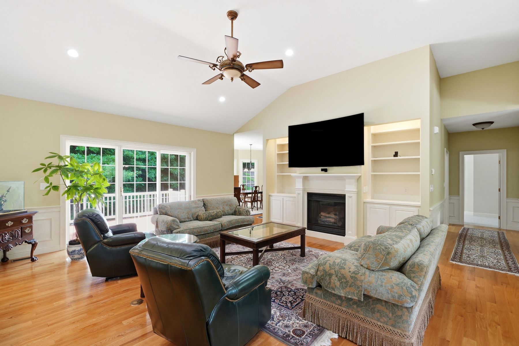 Living room with vaulted ceiling and fireplace