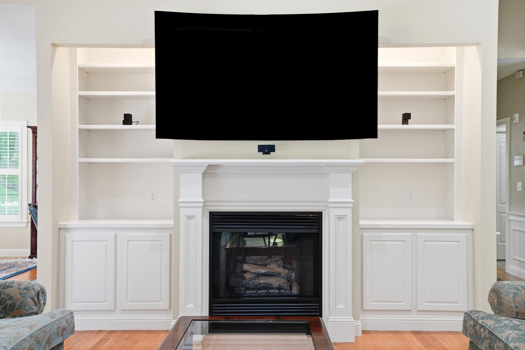 Fireplace framed by custom built-ins (fireplace ready for gas hookup)