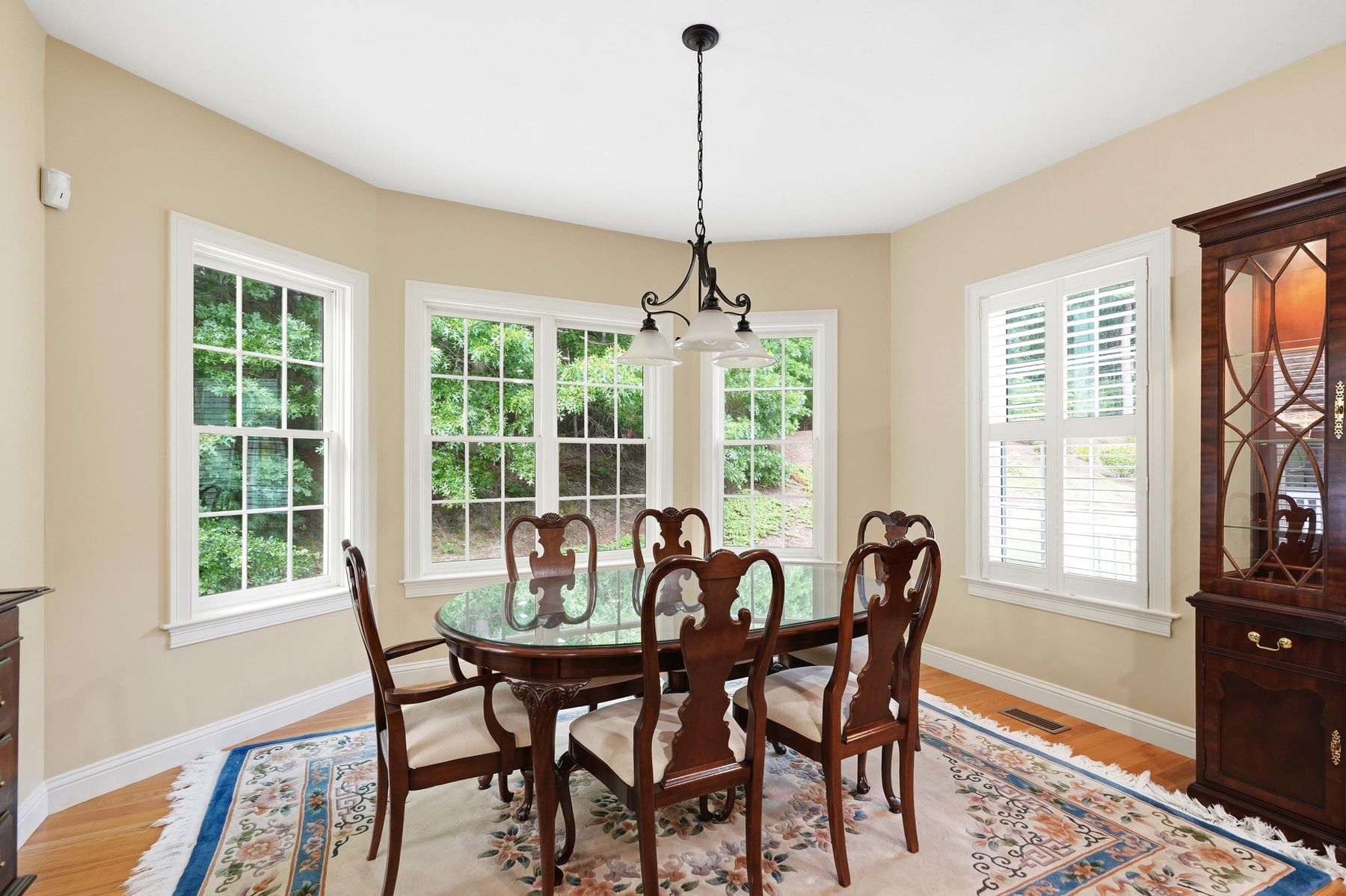 Formal dining room with chandelier and plantation shutters