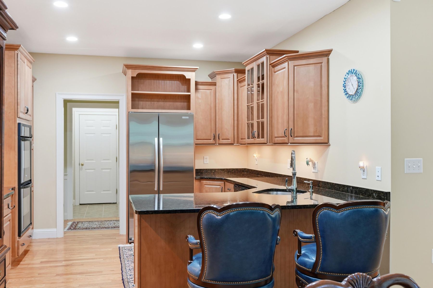 Kitchen with stainless refrigerator and wood cabinetry