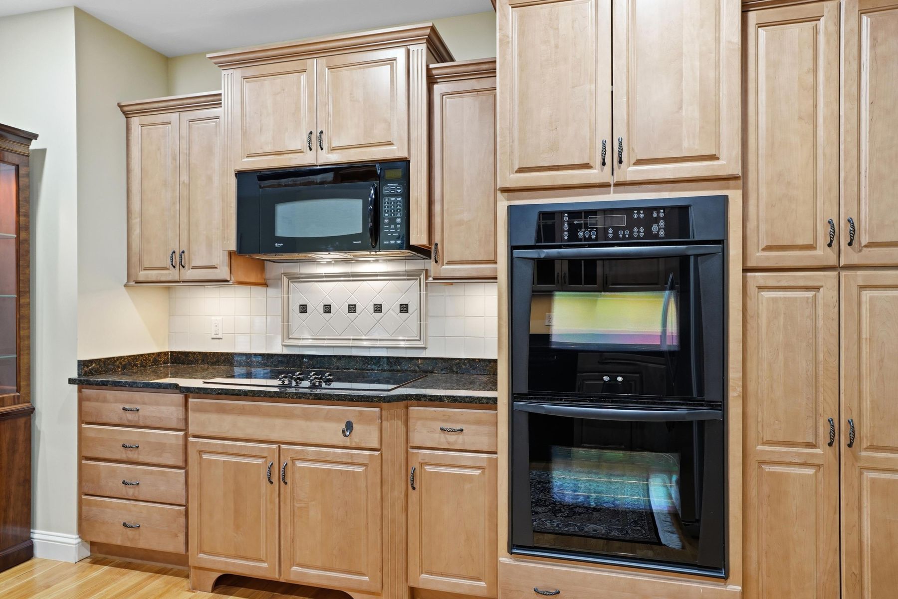 Kitchen with wall oven, microwave and electric cooktop