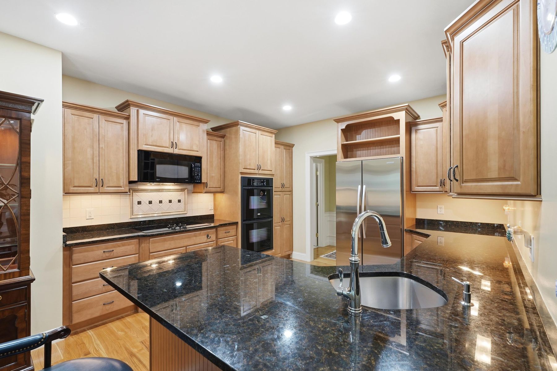 Kitchen island with prep sink and granite countertops