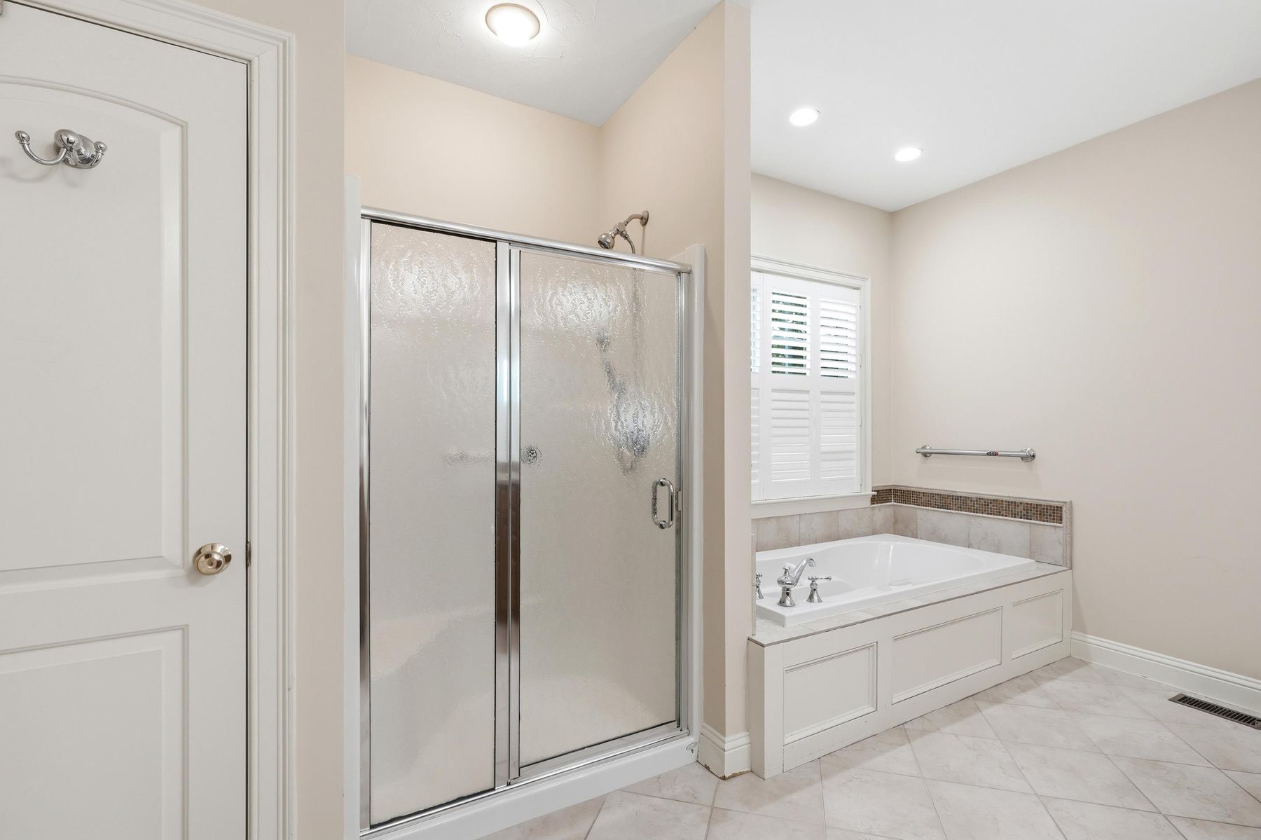 Primary bath with glass shower and soaking tub