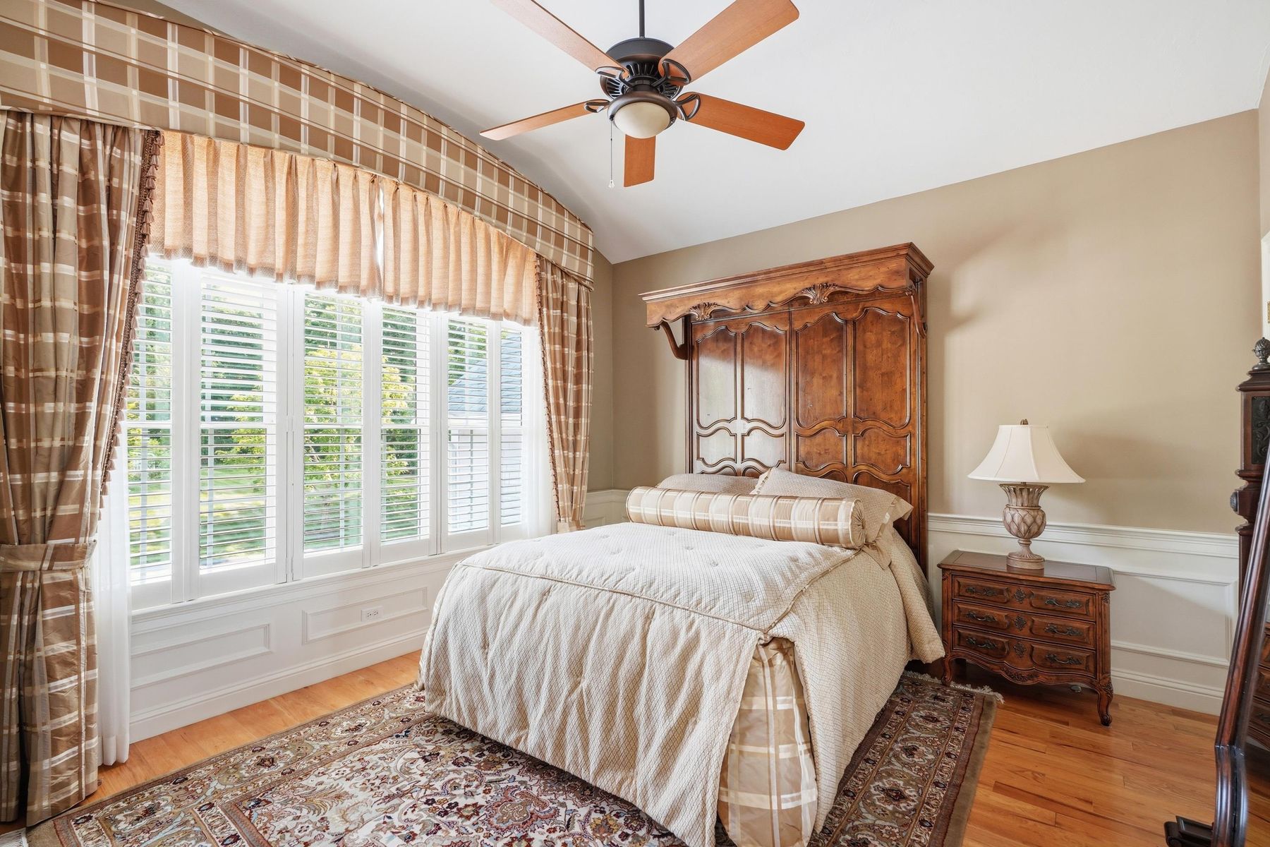 Second bedroom with hardwood floors and window seating