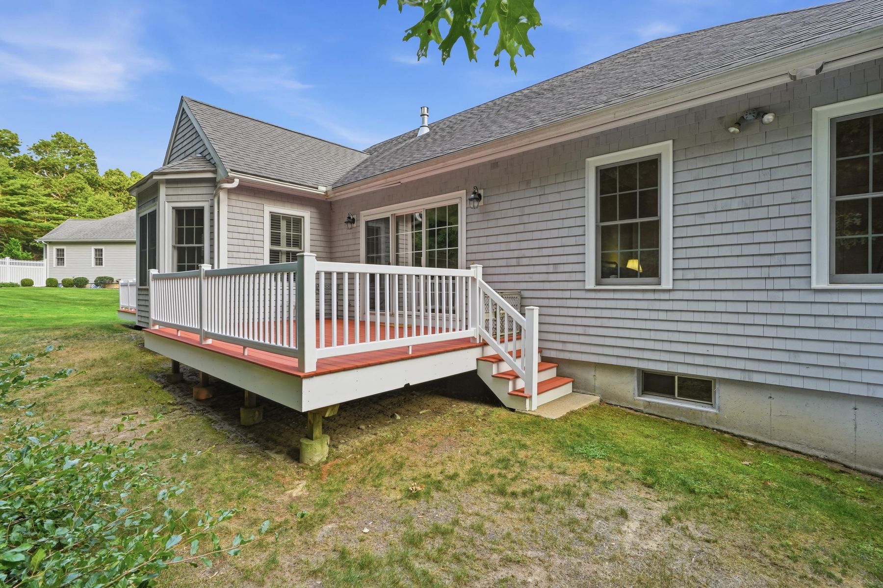 Side rear exterior with deck stairs to the yard