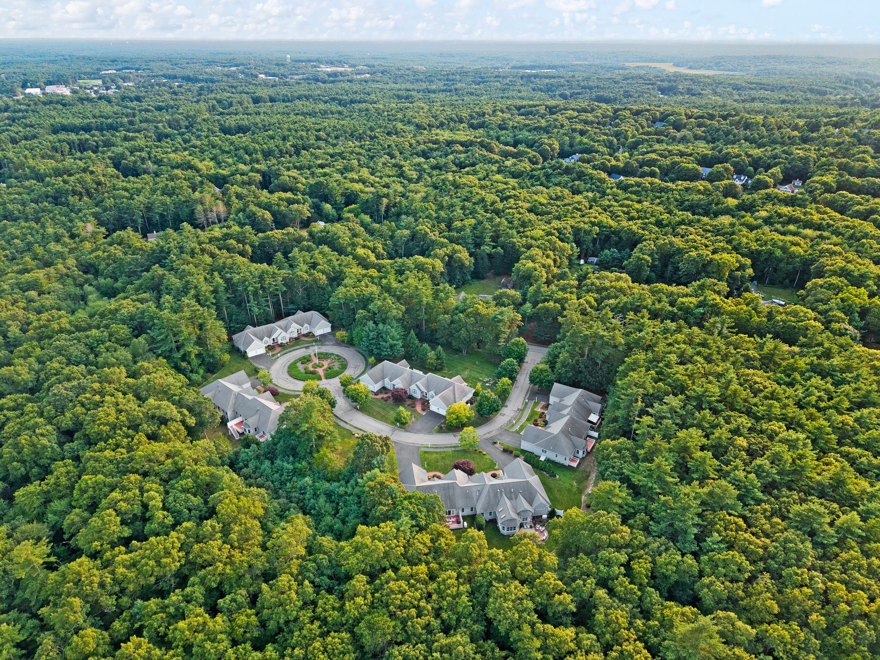 Aerial across the community toward the Marshfield horizon